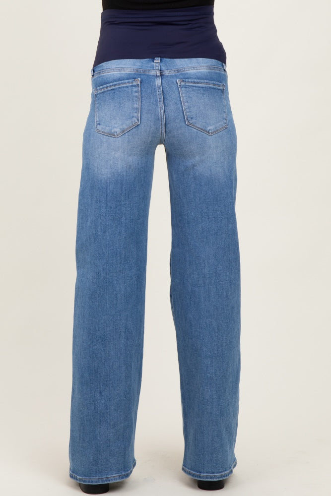 woman wearing light blue maternity jeans with a wide-leg fit and a stretchy black waistband, showing the back view