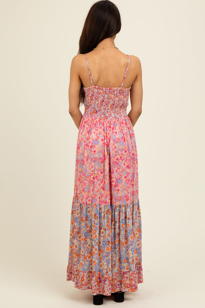 woman wearing a pink floral maxi dress with smocked bodice and tiered skirt, view from the back