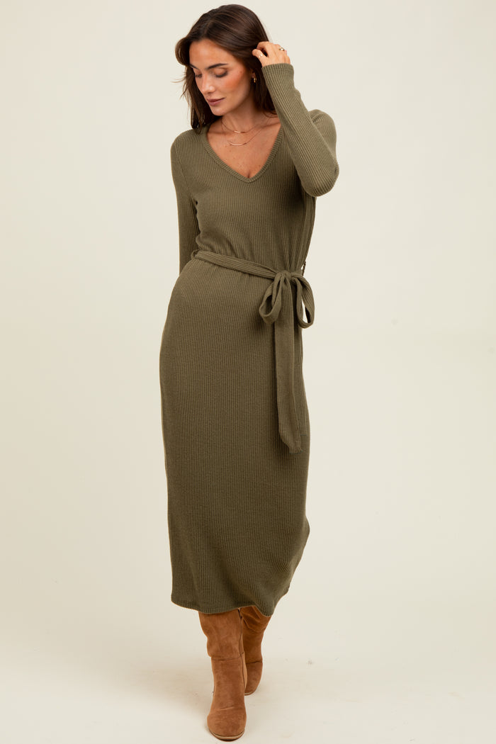 woman wearing an olive green ribbed long sleeve maxi dress with a tie belt and knee-high brown boots