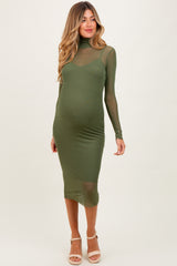 woman wearing a form-fitting olive green maternity dress with long sleeves and a high neckline, showing a baby bump