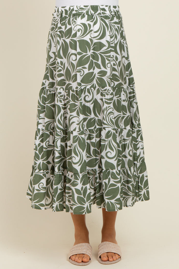 maternity wear green leaf patterned maxi skirt with tiered ruffles and an elastic waistband, model wearing sandals