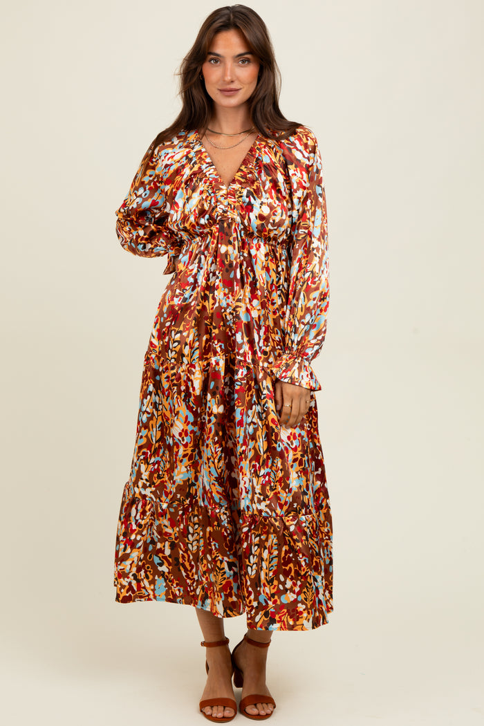 woman wearing a colorful floral print maxi dress with long sleeves and a V-neckline