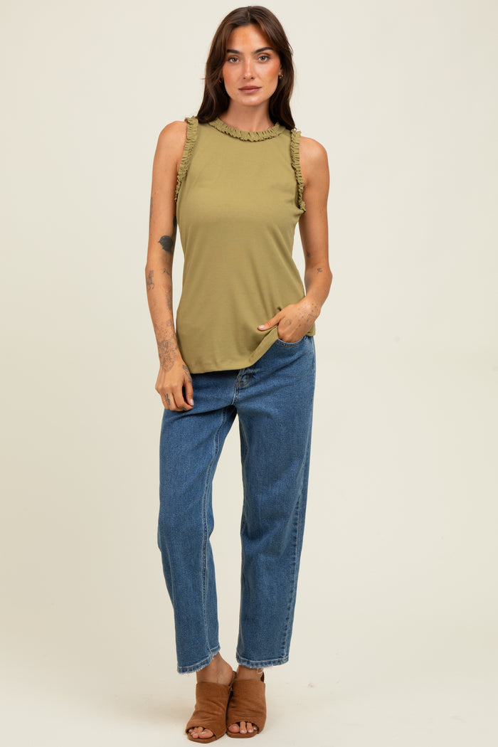 woman wearing an olive green sleeveless top with ruffle details and blue high-waisted straight-leg jeans