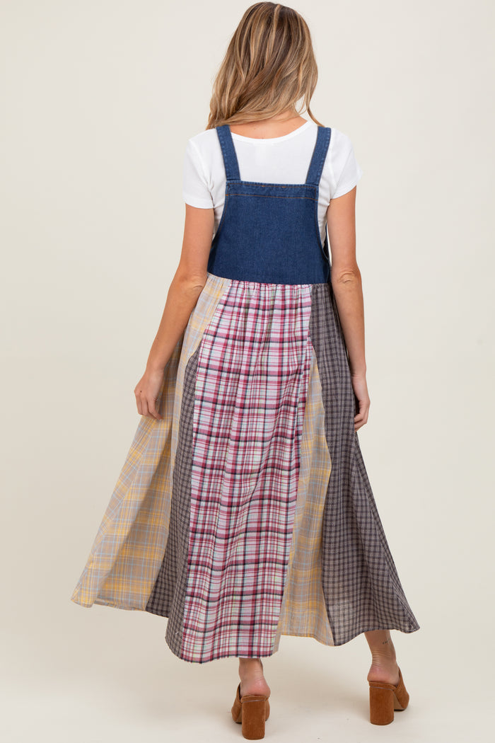 woman wearing a denim maternity dress with a plaid maxi skirt and a white t-shirt underneath, showing a baby bump