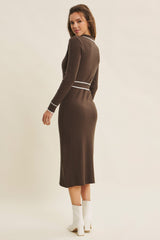 woman wearing a chocolate brown ribbed long sleeve midi dress with white trim details, seen from the back