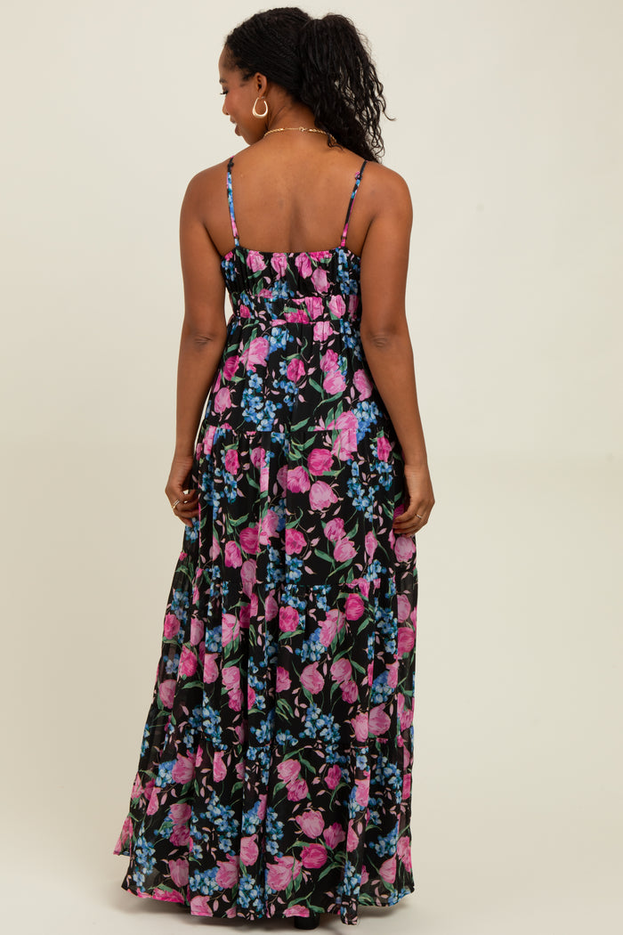 woman wearing a floral maxi dress with thin straps and a flowy silhouette, showing the back view