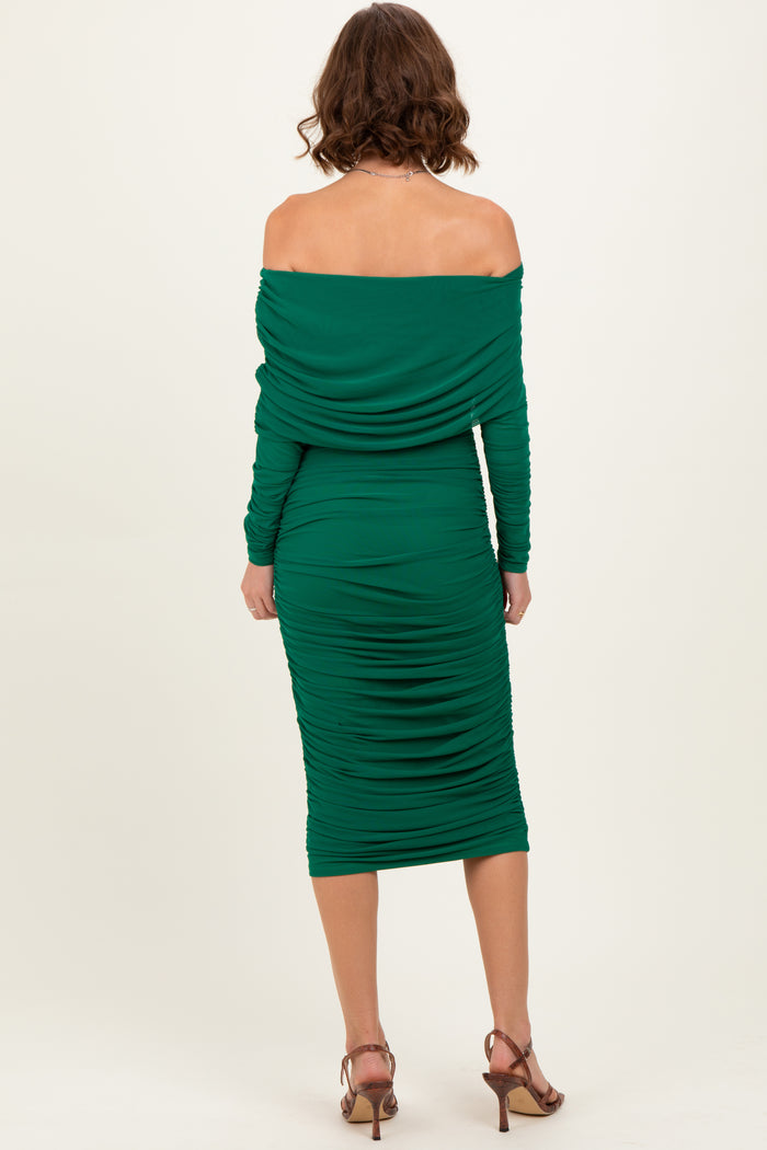 woman wearing a green off-the-shoulder bodycon dress with ruching details and mid-calf length, viewed from the back