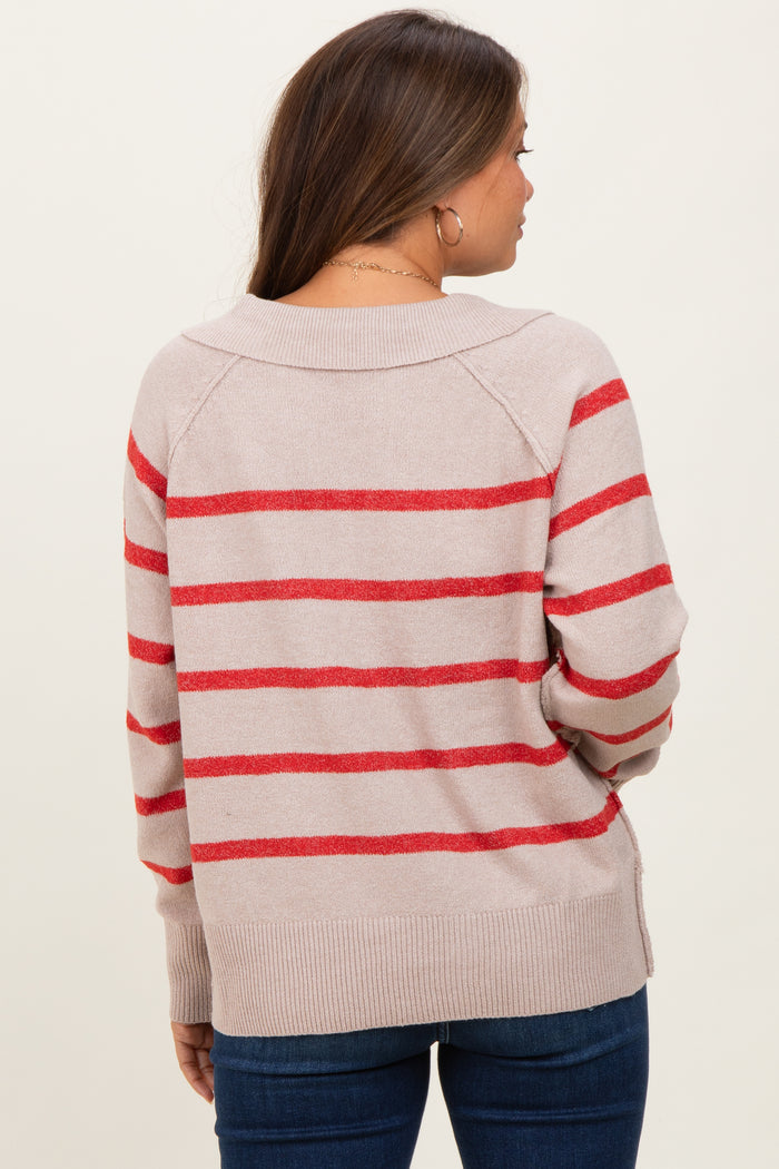 woman wearing a light beige maternity sweater with red stripes, viewed from the back