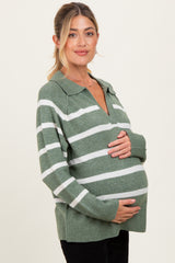 woman wearing a green and white striped maternity sweater with a collar and holding her baby bump
