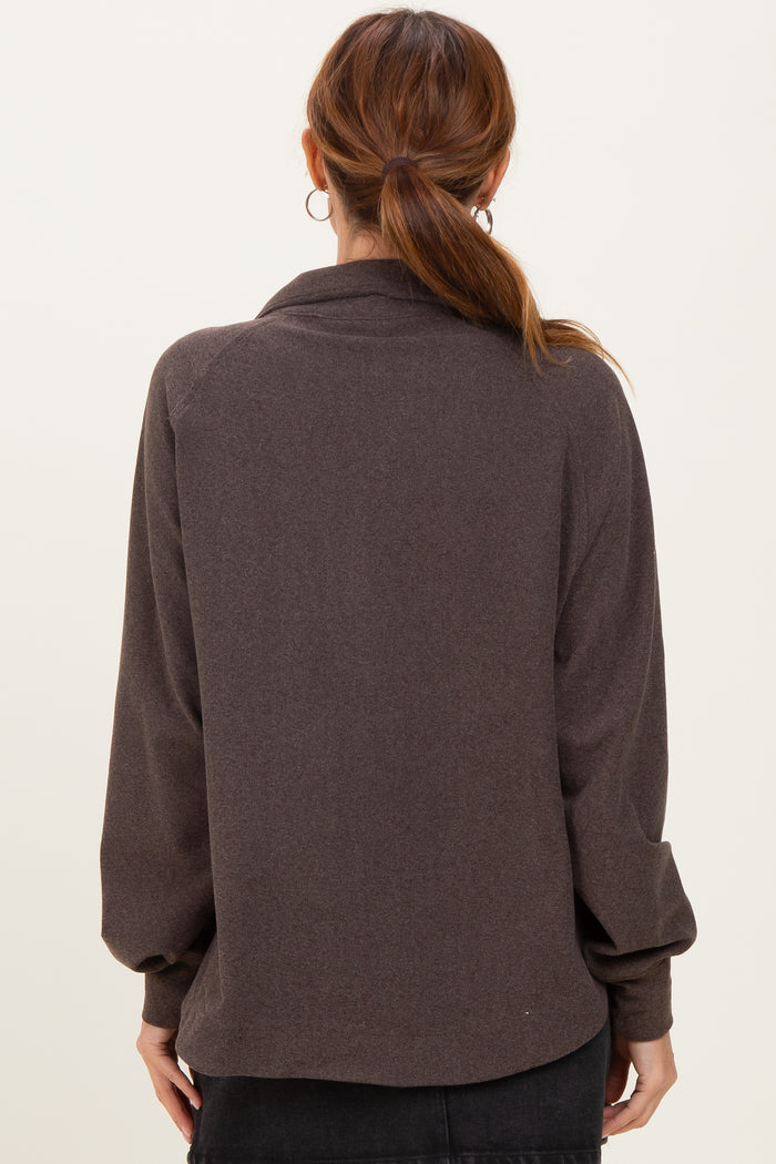 woman wearing a dark brown oversized sweater with a relaxed fit and long sleeves, viewed from the back