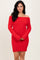 woman wearing a red off-the-shoulder sweater dress with a ribbed texture and long sleeves