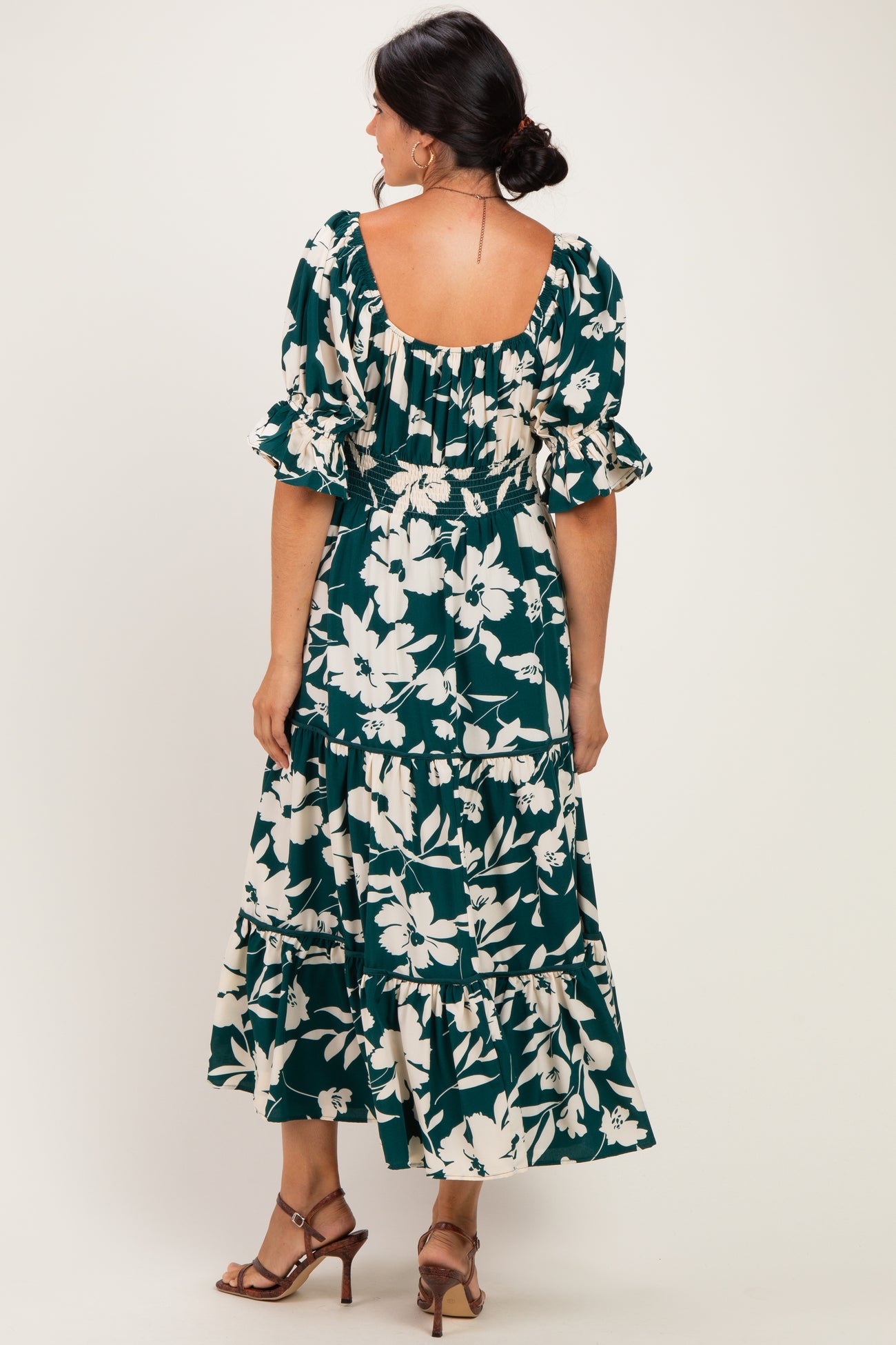 woman wearing a green floral maxi dress with ruffled sleeves and a smocked back