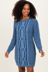 woman wearing a blue cable knit sweater dress with long sleeves and a ribbed texture