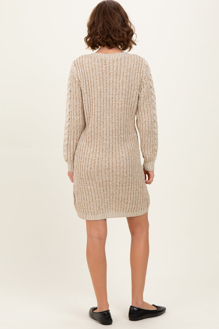 woman wearing a beige knitted sweater dress with long sleeves and a relaxed fit, shown from the back