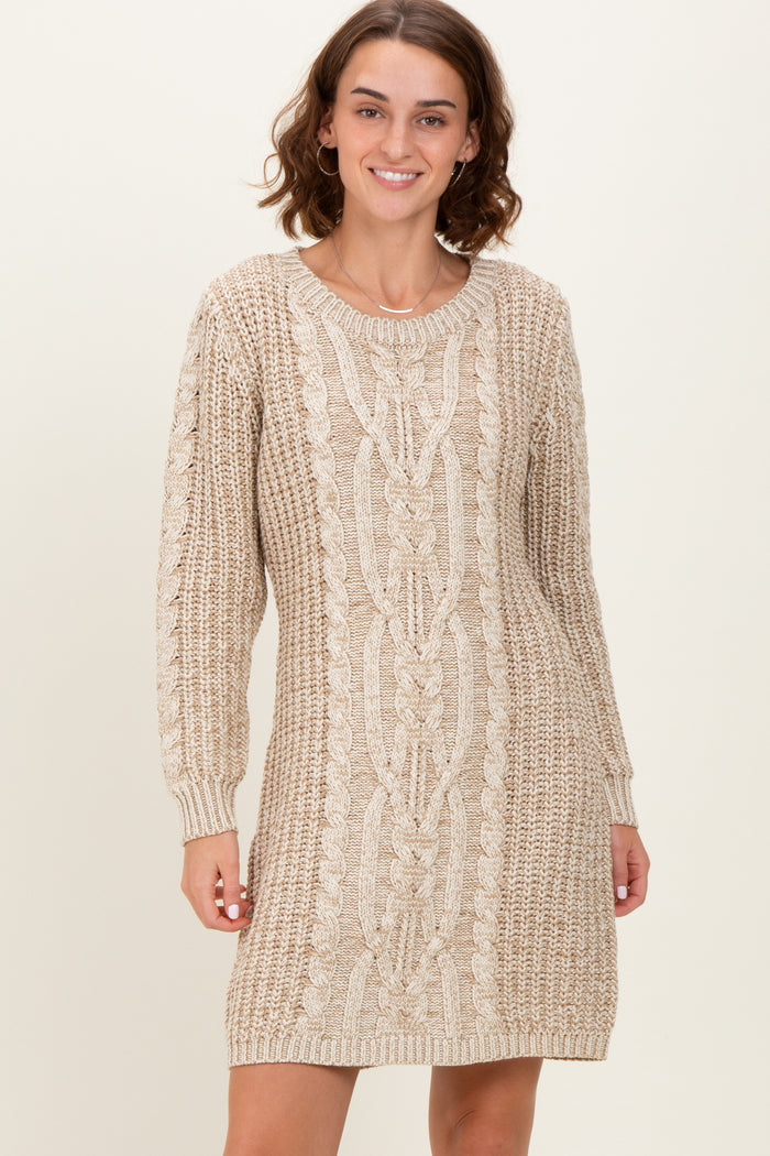 woman wearing a beige cable knit sweater dress with long sleeves and a relaxed fit