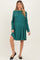 woman wearing a green striped long sleeve maternity dress with a fitted bodice and flowing skirt, showing her baby bump