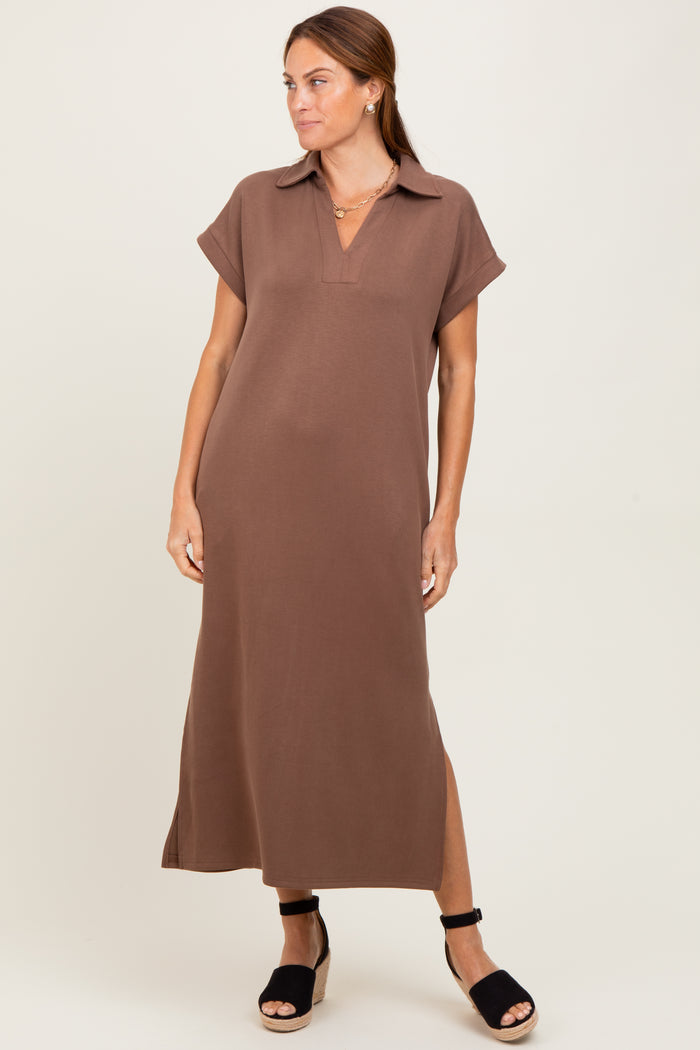 woman wearing a brown short sleeve maxi dress with a collar and side slits