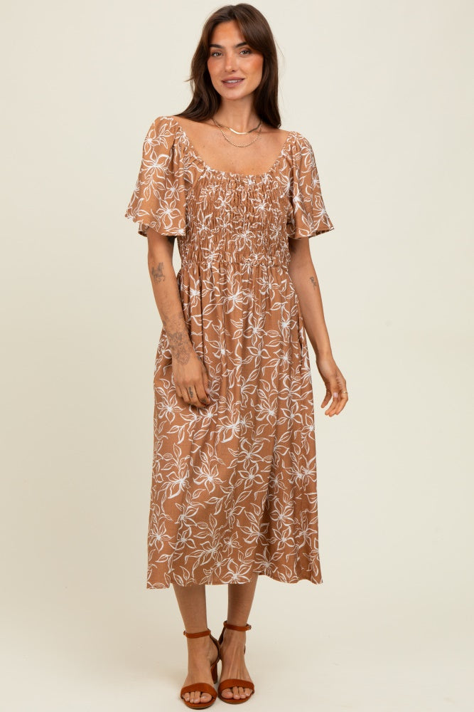 woman wearing a brown floral midi dress with short sleeves and a smocked bodice