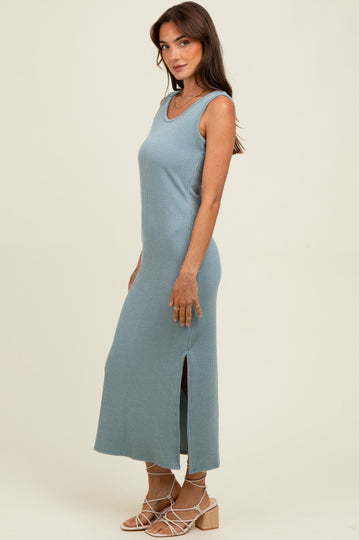 woman wearing a ribbed light blue sleeveless maxi dress with side slits and a form-fitting silhouette