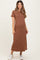 woman wearing a brown striped maternity dress with short sleeves and a fitted silhouette, paired with white sneakers