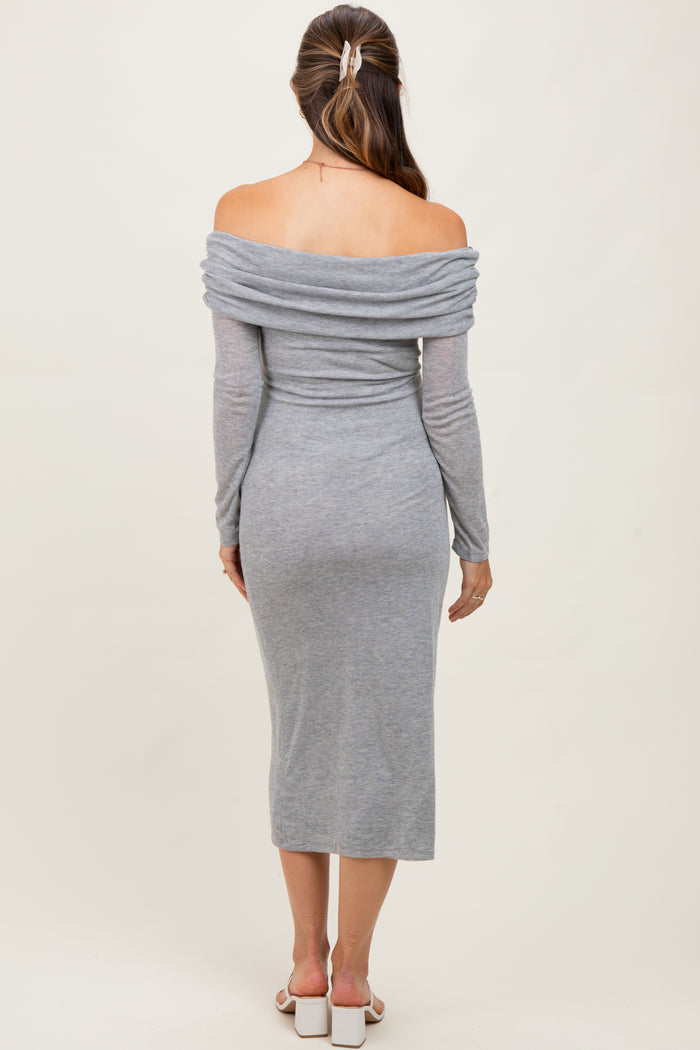woman wearing a gray off-shoulder maternity dress with long sleeves and a fitted midi length