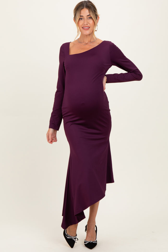 woman wearing a purple long sleeve maternity dress with an asymmetrical hem and a visible baby bump