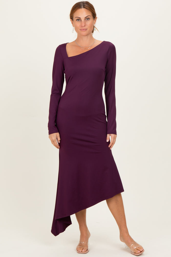 woman wearing a purple long sleeve asymmetrical dress with a sweetheart neckline and a fitted silhouette