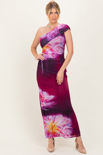 woman wearing a one-shoulder maxi dress in pink and purple with floral print
