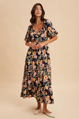 woman wearing a floral maxi dress with short puff sleeves and a square neckline