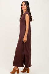 woman wearing a brown sleeveless maxi dress with side slits and styled with brown block heel sandals