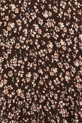 brown floral print dress with small white and peach flowers and a tiered design