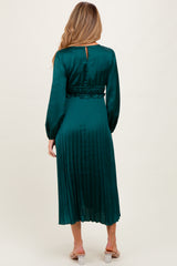 maternity wear in emerald green with pleated skirt and long sleeves, shown from the back