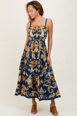 woman wearing a navy blue floral midi dress with spaghetti straps and a fitted bodice, styled with heeled sandals