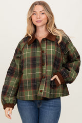 woman wearing a green and brown plaid quilted jacket with a collar and button front, styled with blue jeans