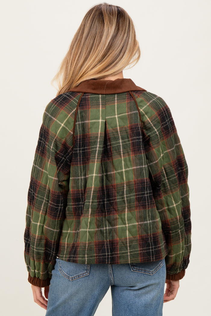 woman wearing a green and brown plaid maternity jacket with a collar and ribbed cuffs, seen from the back