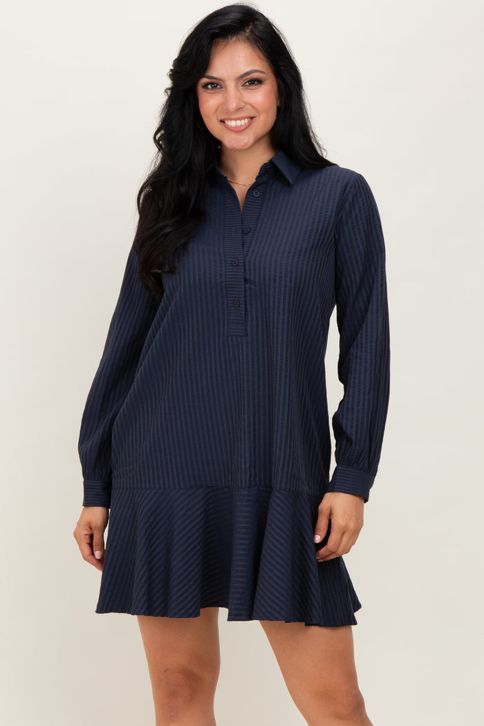 woman wearing a navy blue striped long sleeve shirt dress with a flared hem and button placket