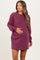 woman wearing a burgundy long sleeve maternity dress and holding her baby bump