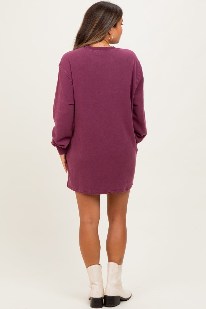 woman wearing a dark purple oversized maternity dress with long sleeves and a relaxed fit, showing her back