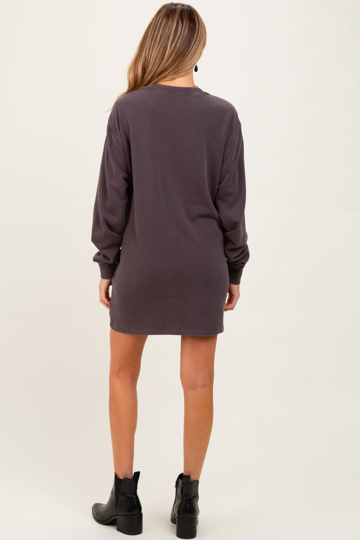 woman wearing a dark gray long sleeve maternity dress, shown from the back, with ankle boots
