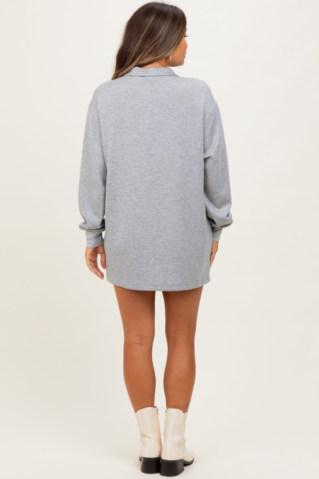 woman wearing a grey long sleeve maternity sweatshirt dress, view from the back