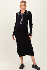 woman wearing a black ribbed maternity dress with a button-up collar and long sleeves, showing her baby bump