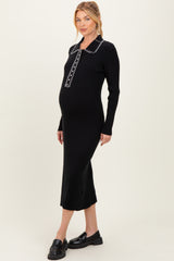 woman wearing a black ribbed maternity dress with a collar and long sleeves, showing her baby bump