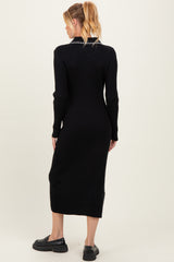 woman wearing a black ribbed maternity dress with long sleeves and a fitted silhouette, showing her baby bump