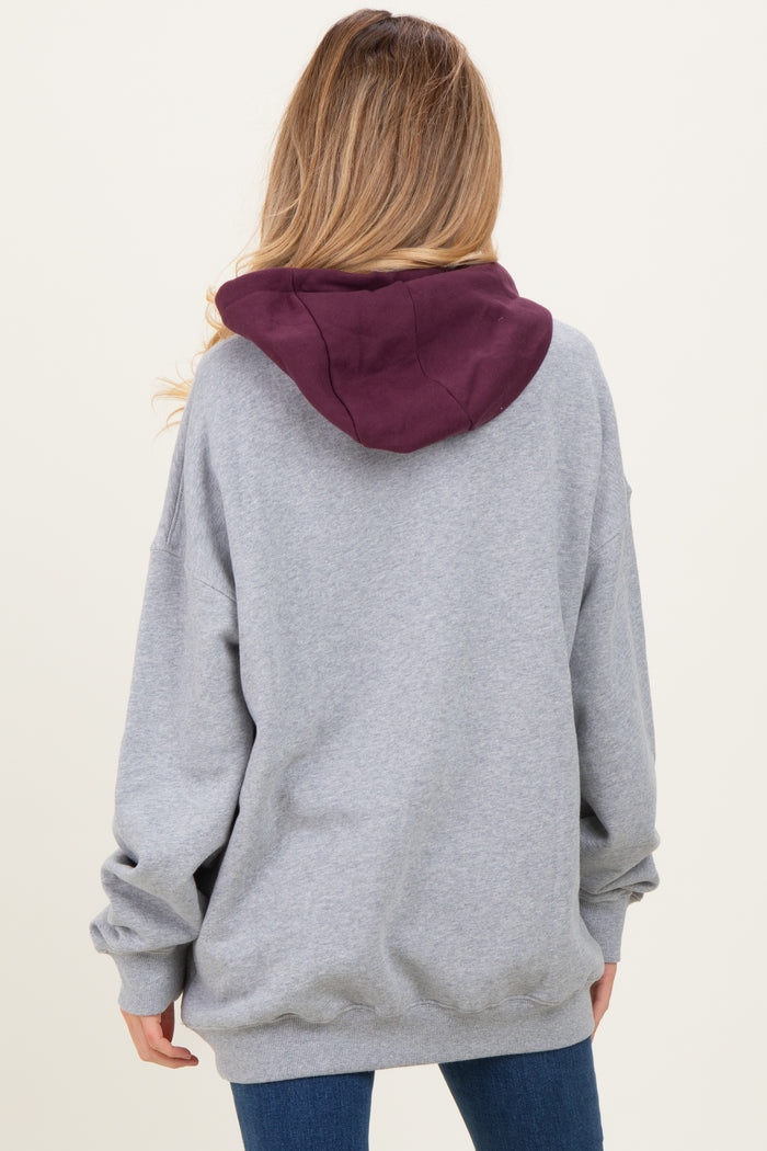 woman wearing a gray maternity hoodie with a maroon hood, viewed from the back, showing relaxed fit and casual style