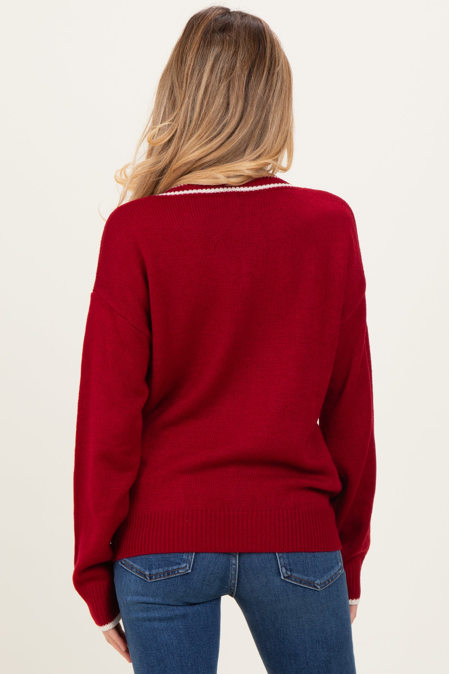 woman wearing a red maternity sweater with a relaxed fit and long sleeves, viewed from the back