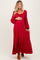 woman wearing a red long sleeve maternity dress with a tiered skirt and holding her baby bump