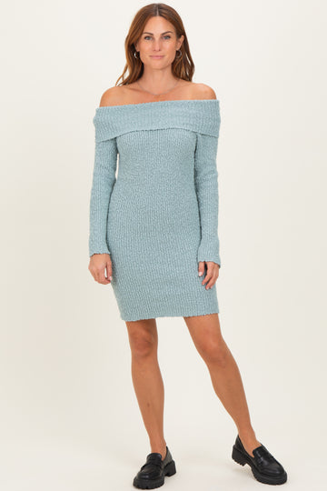 woman wearing a light blue off-the-shoulder ribbed sweater dress with long sleeves and a fitted silhouette