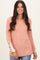 woman wearing a dusty rose ribbed long sleeve top with lace detail and button accents on the sleeves