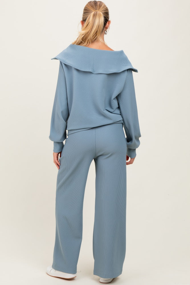 woman wearing a light blue maternity lounge set with a relaxed fit top and wide-leg pants, showing her back