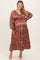 woman wearing a maternity plus long sleeve leopard print dress with a tiered skirt and a visible baby bump